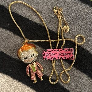 BETSEY JOHNSON GOLD PLATED JOKER NECKLACE. 28 IN. CHAIN